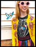 Girl in Sunglasses wearing Bird Necklaces with Blue Cartoon Bird on her shoulder